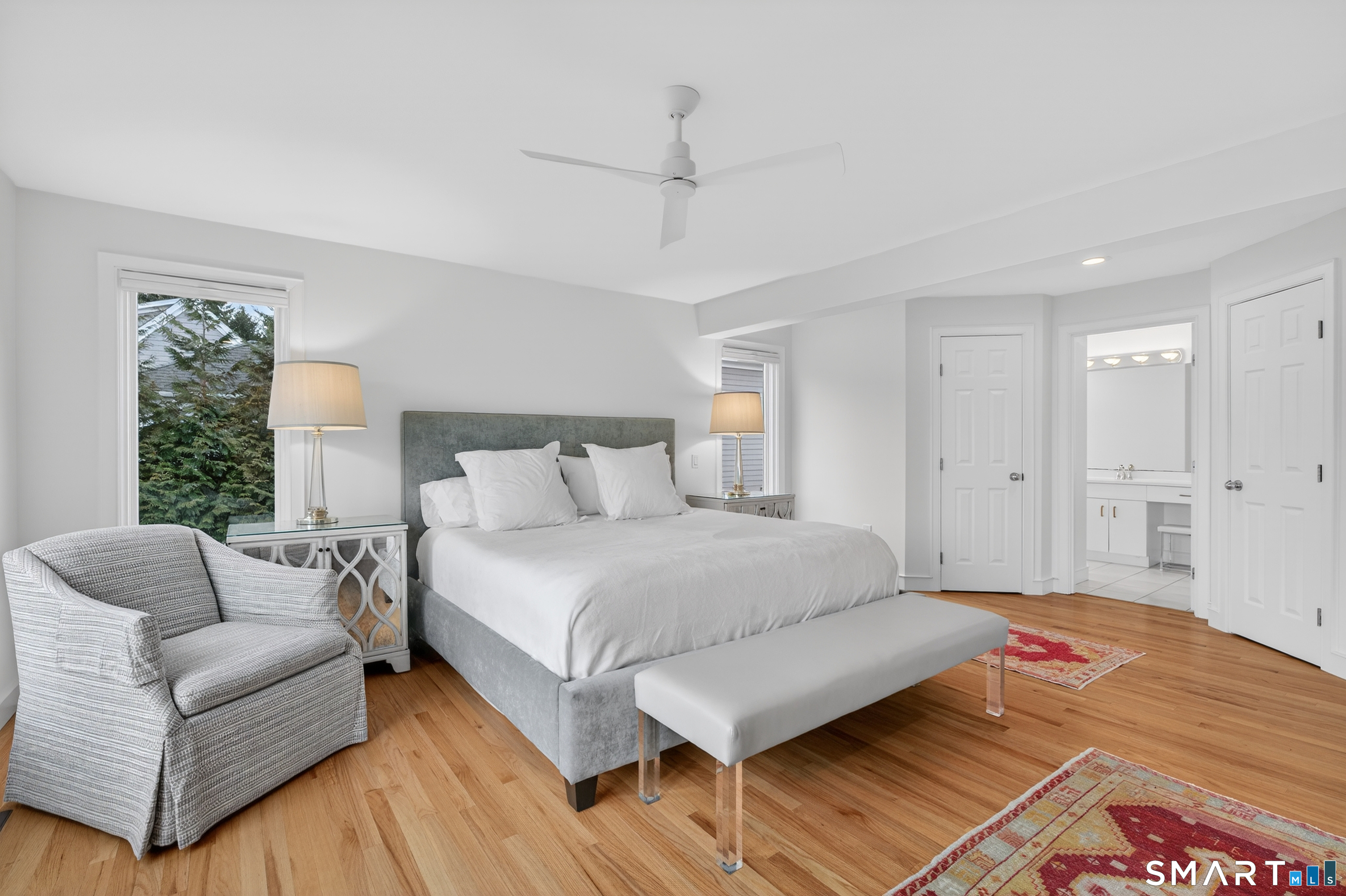 83 Old North Road Stonington, CT 06355 - Photo 18 of 40 a spacious bedroom with a bed a couch and a window