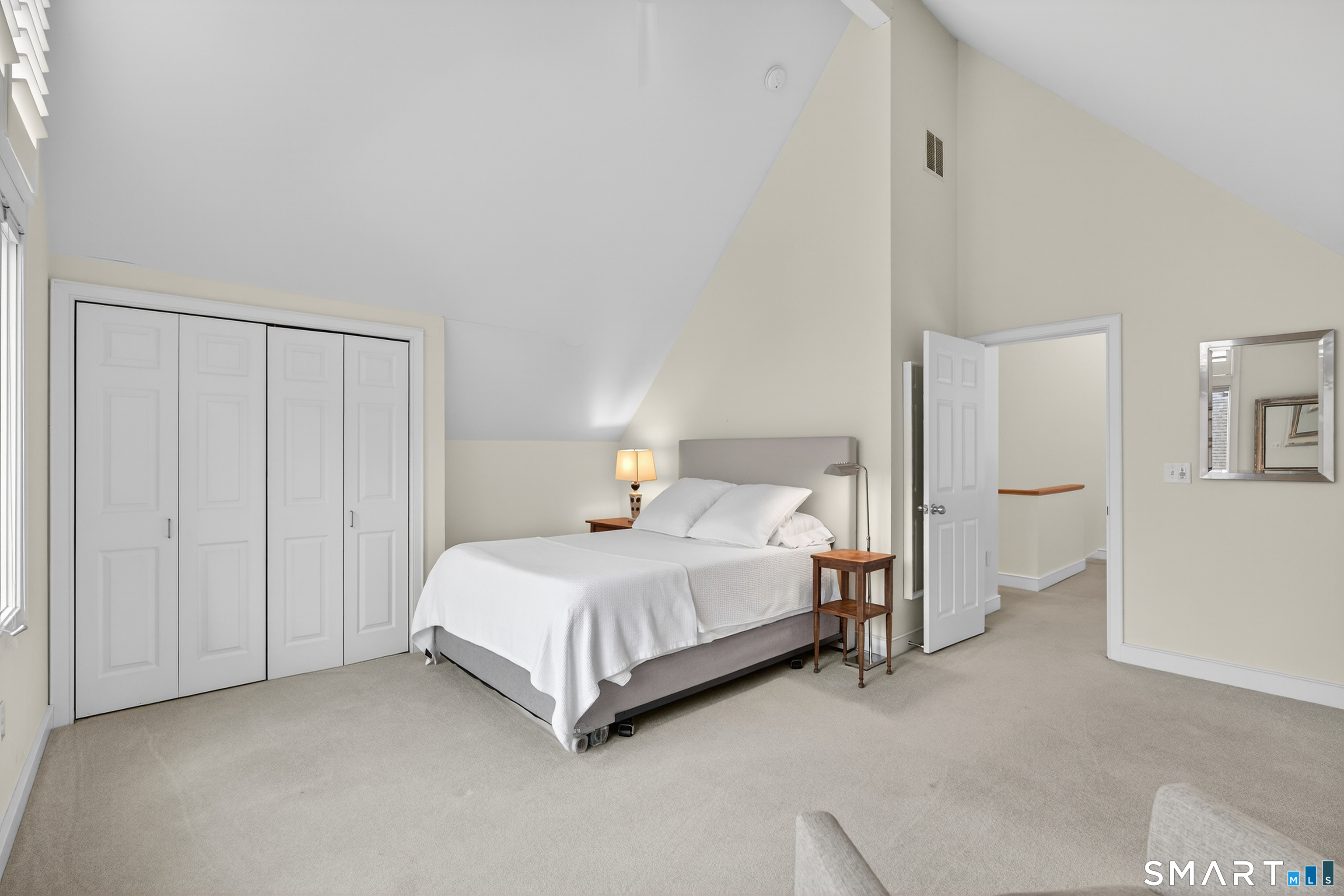 83 Old North Road Stonington, CT 06355 - Photo 23 of 40 a bed room with a bed and a night stand