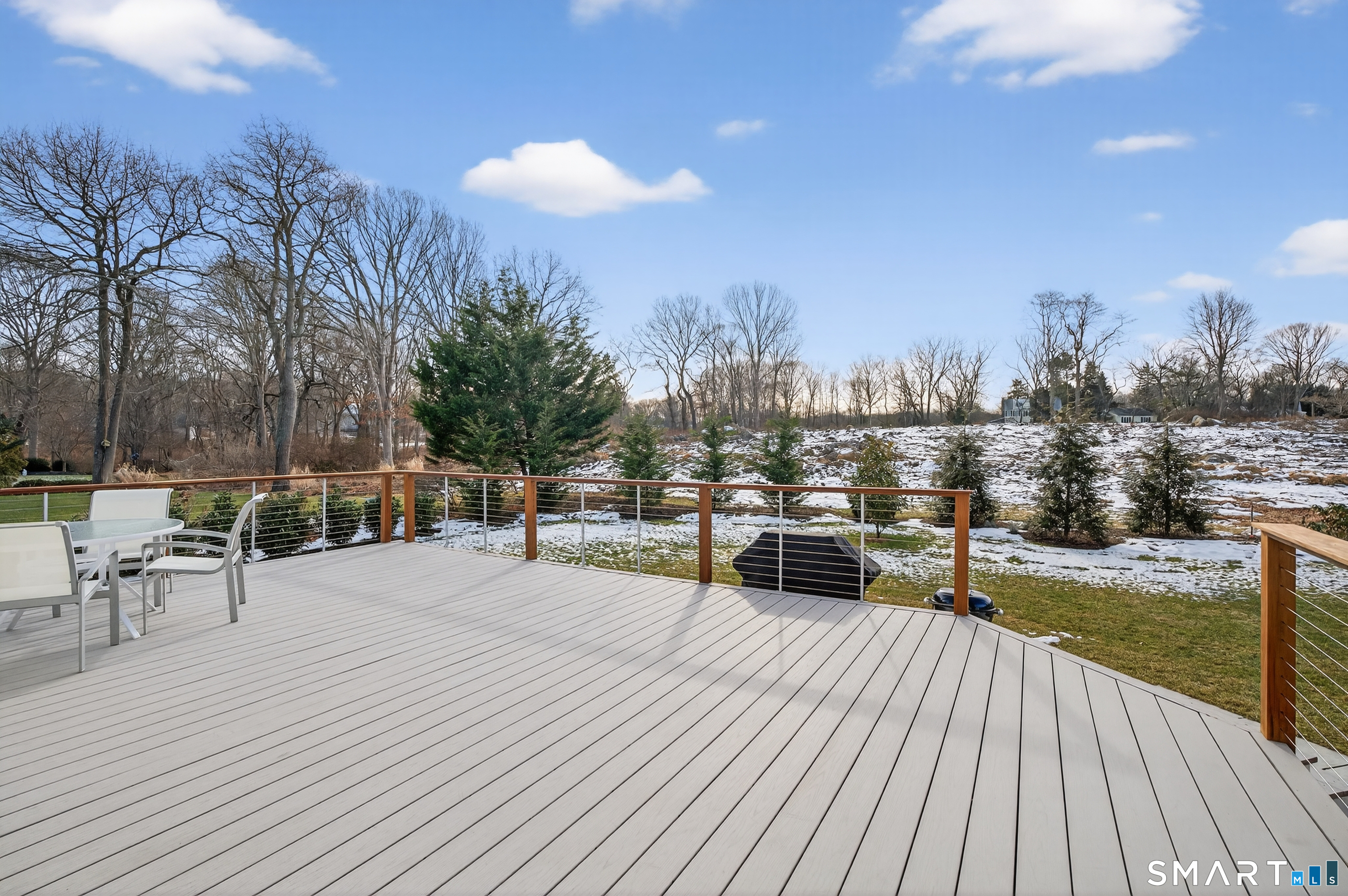83 Old North Road Stonington, CT 06355 - Photo 10 of 40 a view of a terrace with chairs and wooden floor