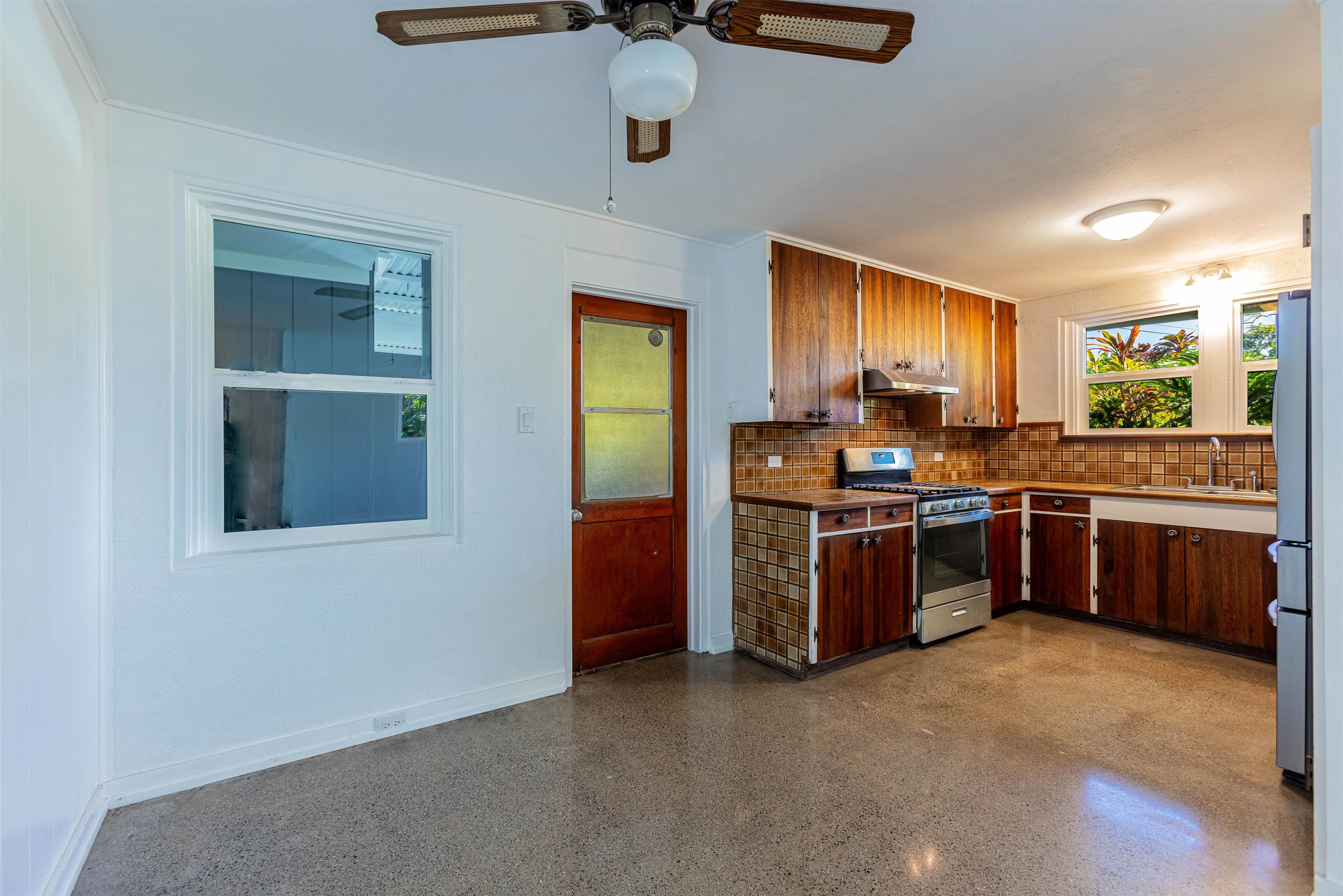 720 Mopua Street Haiku, HI 96708 - Photo 3 of 20 a kitchen with stainless steel appliances kitchen island granite countertop a stove a sink and a refrigerator