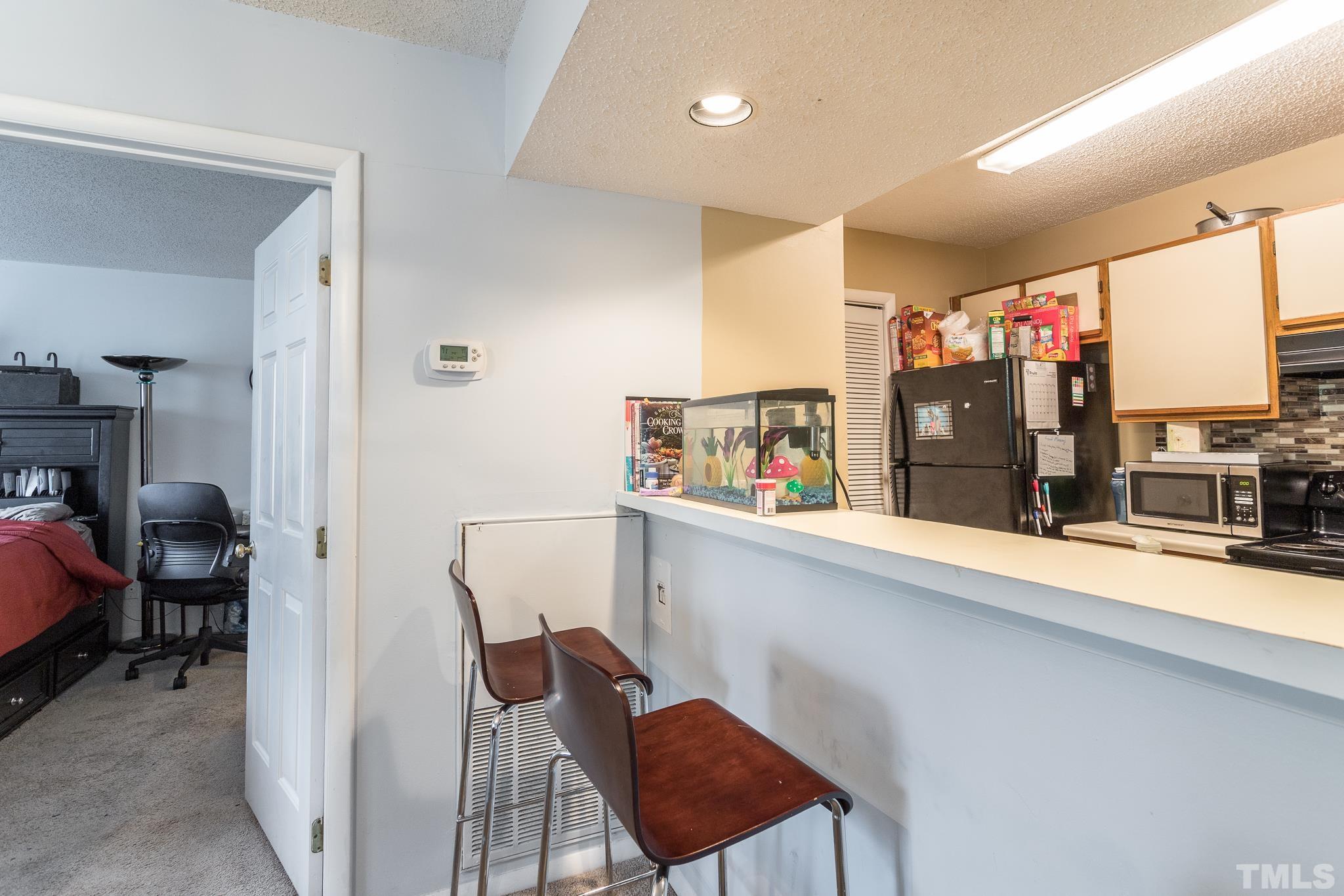 3706 Chimney Ridge Place, Unit 205 Durham, NC 27713 - Photo 11 of 18 a dinning room with furniture and a flat screen tv