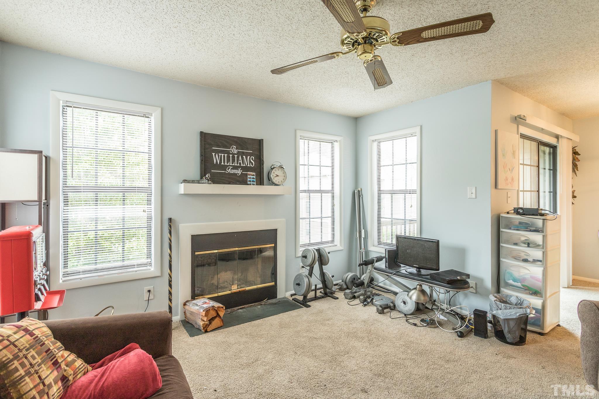 3706 Chimney Ridge Place, Unit 205 Durham, NC 27713 - Photo 13 of 18 a living room with furniture window and a fireplace