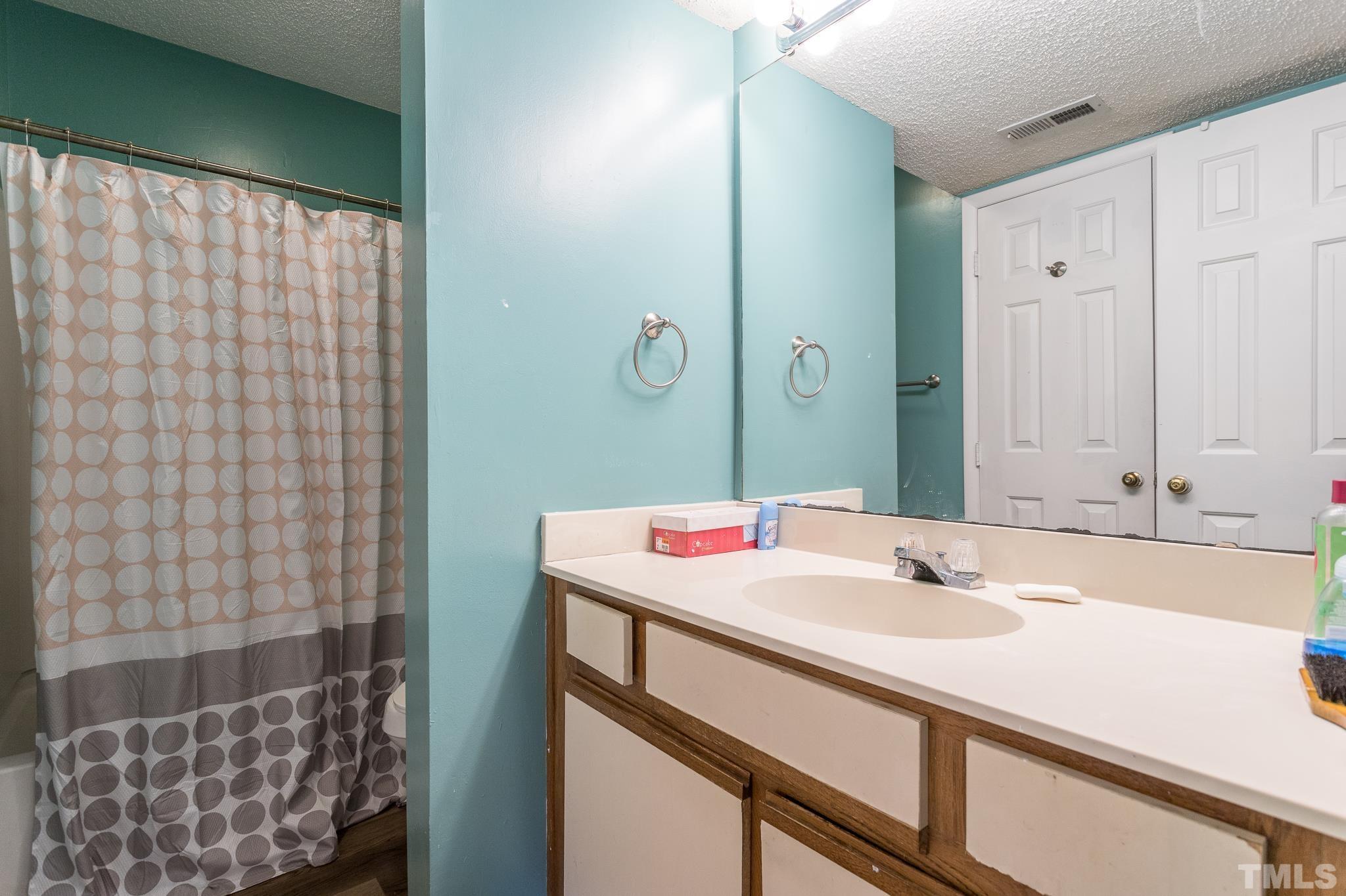 3706 Chimney Ridge Place, Unit 205 Durham, NC 27713 - Photo 15 of 18 a bathroom with a sink and a mirror