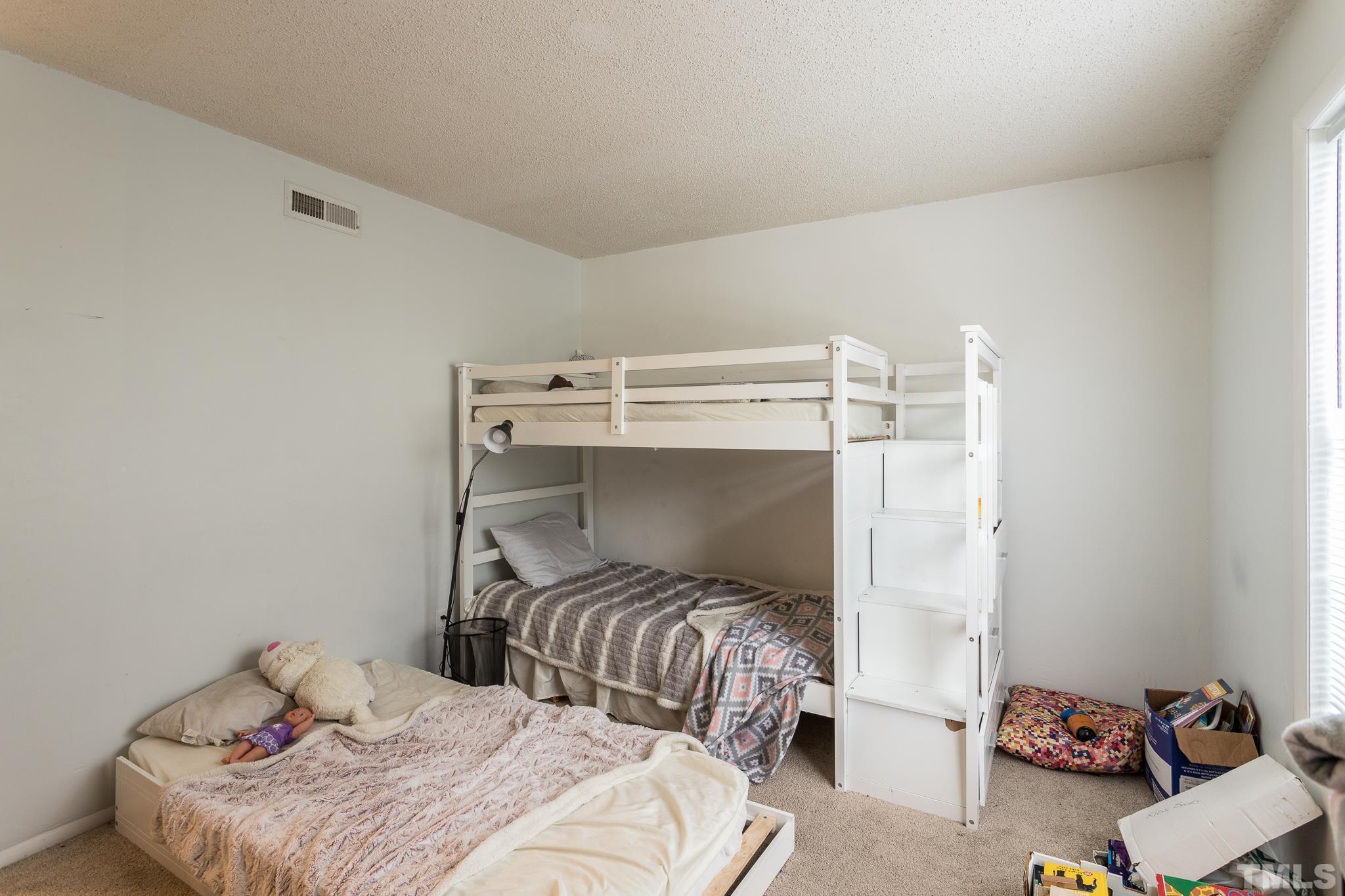 3706 Chimney Ridge Place, Unit 205 Durham, NC 27713 - Photo 16 of 18 a bedroom with a bed and a mirror
