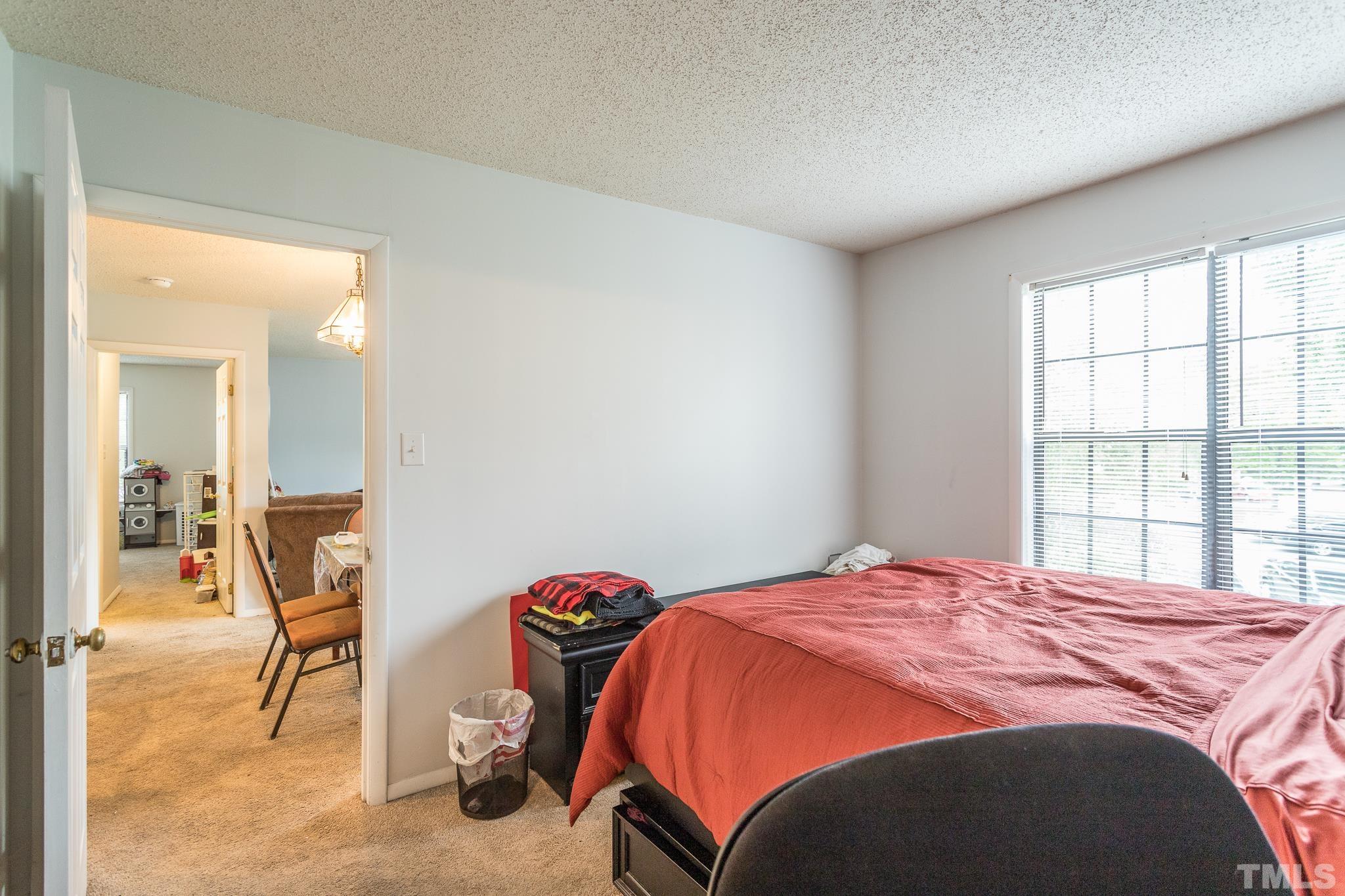 3706 Chimney Ridge Place, Unit 205 Durham, NC 27713 - Photo 17 of 18 a bedroom with a bed and a window