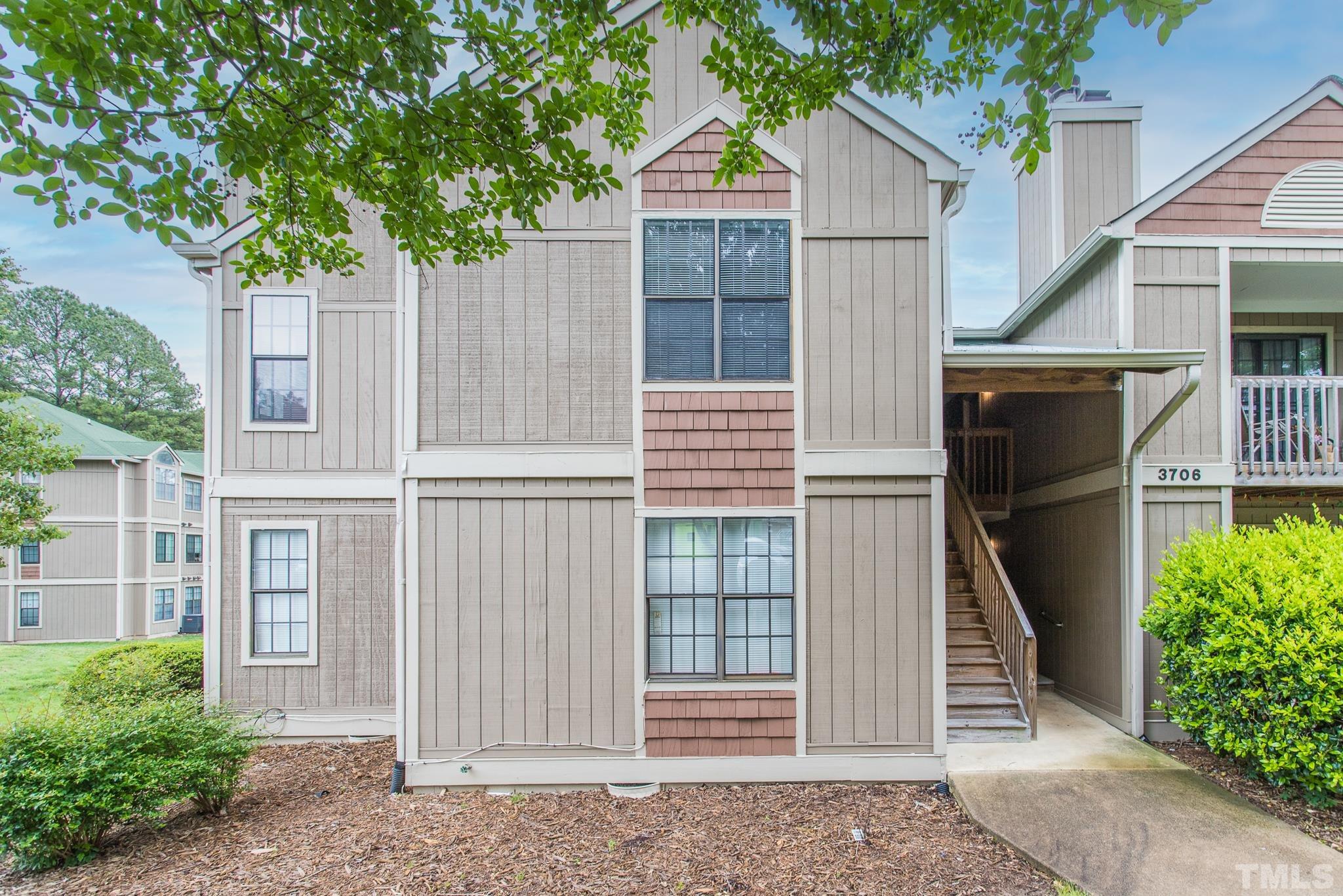 3706 Chimney Ridge Place, Unit 205 Durham, NC 27713 - Photo 2 of 18 a front view of a house with a garage
