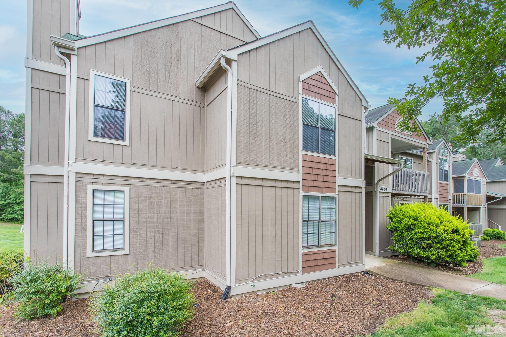 3706 Chimney Ridge Place, Unit 205 Durham, NC 27713 - Photo 3 of 18 a front view of a house with garden
