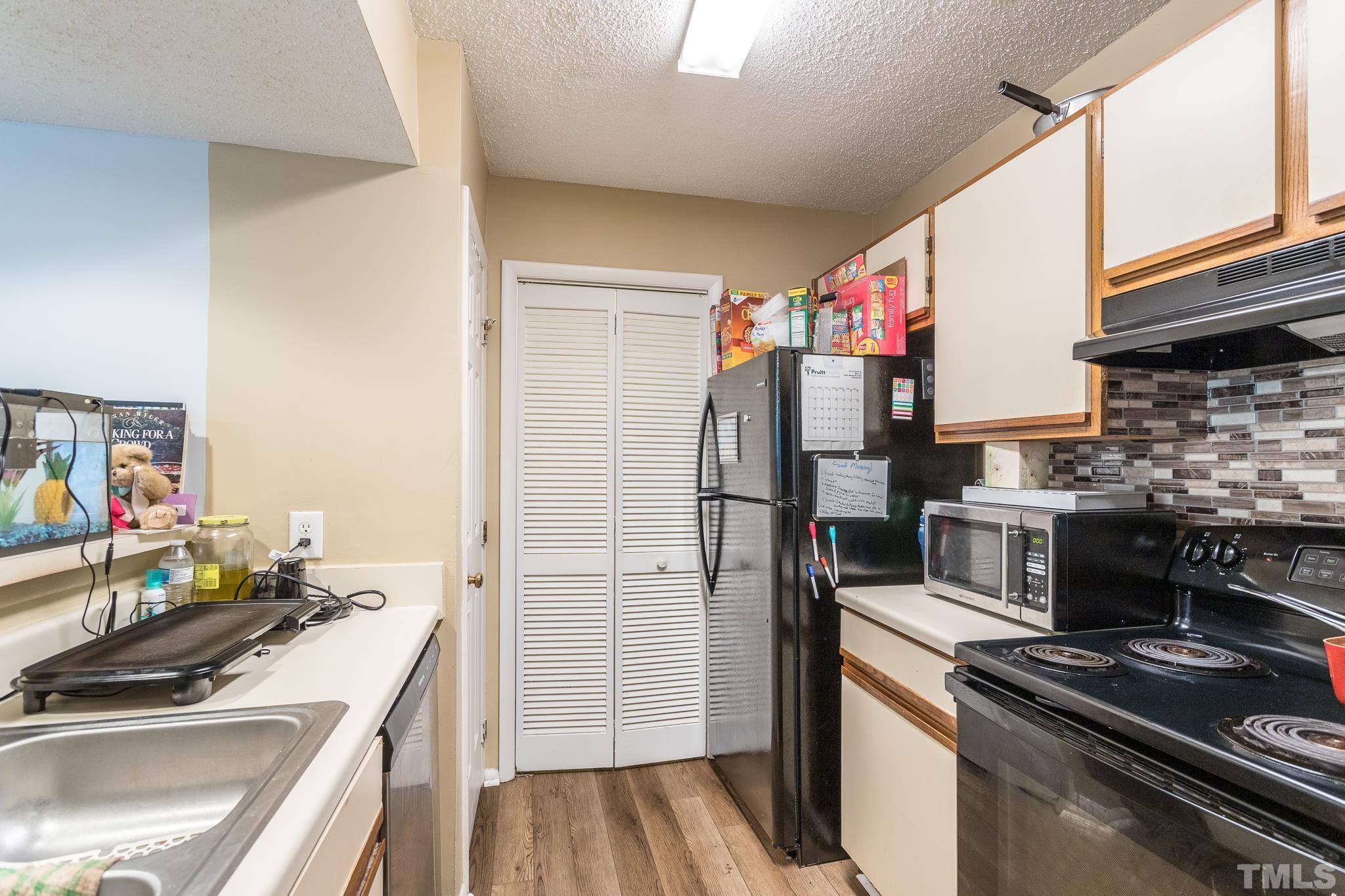 3706 Chimney Ridge Place, Unit 205 Durham, NC 27713 - Photo 9 of 18 a kitchen with a sink stove and refrigerator