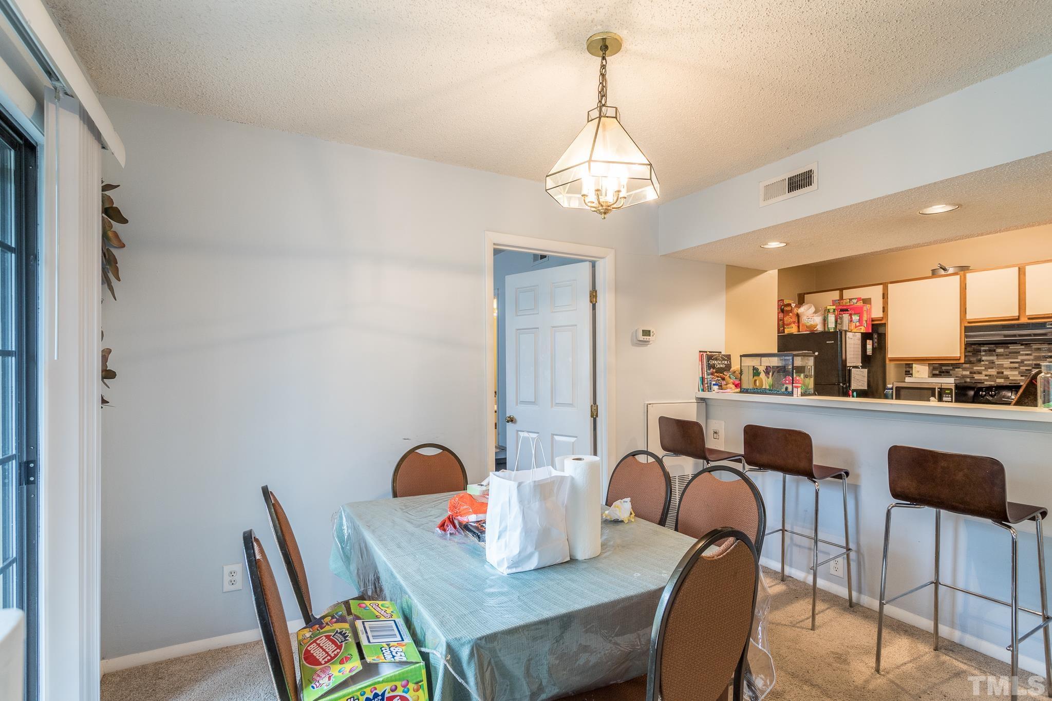 3706 Chimney Ridge Place, Unit 205 Durham, NC 27713 - Photo 10 of 18 a view of a dining room with furniture