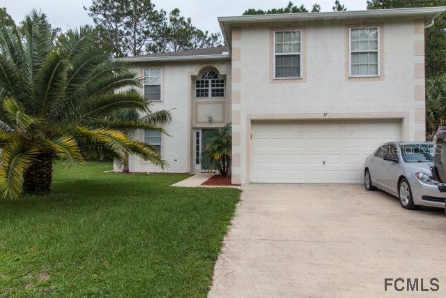 17 Llestone Path Palm Coast, FL 32164 - Photo 1 of 1 a couple of cars parked in front of a house