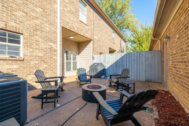 a backyard of a house with table and chairs