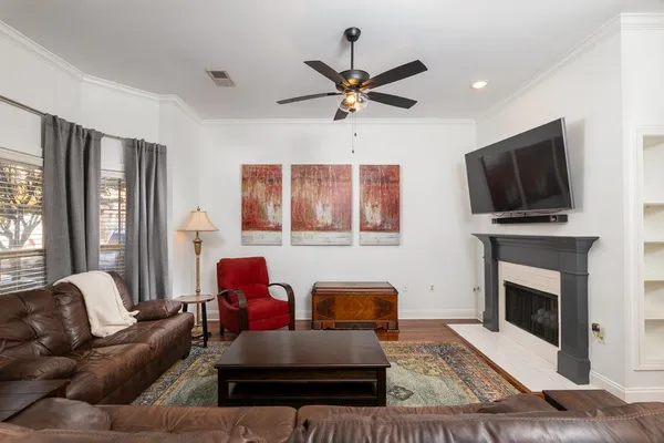 a kitchen with stainless steel appliances a dining table chairs stove refrigerator and cabinets