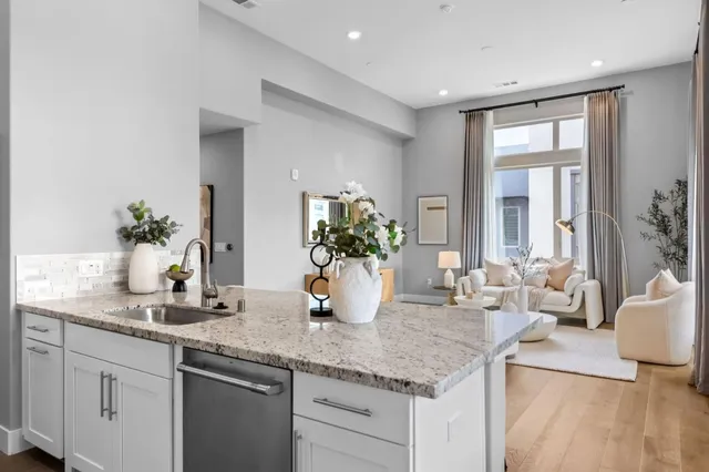 a kitchen with stainless steel appliances a sink stove and refrigerator