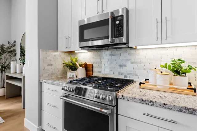 a kitchen with sink and view of living room