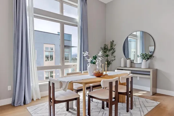 a view of a dining room with furniture and wooden floor