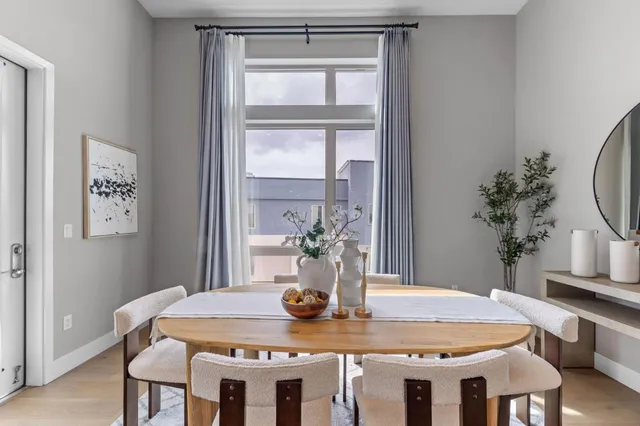 a dining room with furniture and wooden floor