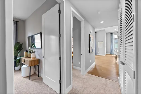 a large white bedroom with a bed and a couch