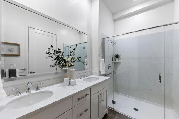 a bathroom with a bathtub shower sink and a mirror