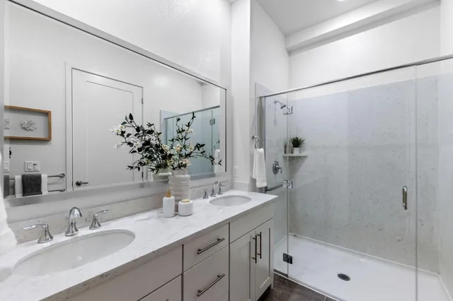 a bathroom with a bathtub shower sink and a mirror