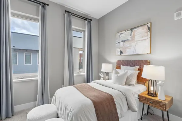 a bedroom with a bed table and couch