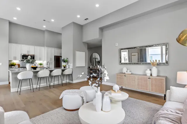 a living room with furniture and kitchen view