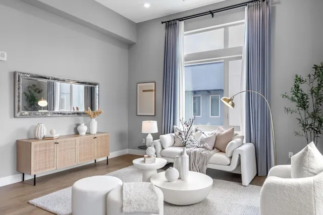 a living room with furniture and a potted plant