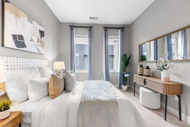 a front view of a multi story residential apartment building with yard and retail shops