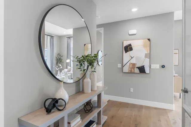 a hallway with sink and mirror