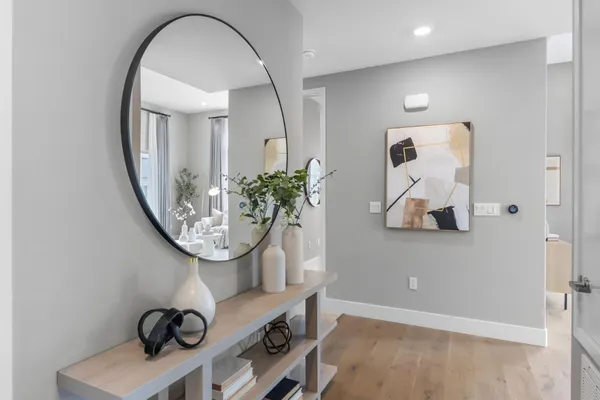 a hallway with sink and mirror