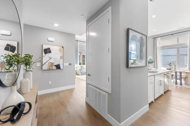 a dining room with furniture potted plants and wooden floor