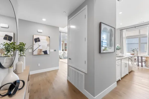 a dining room with furniture potted plants and wooden floor