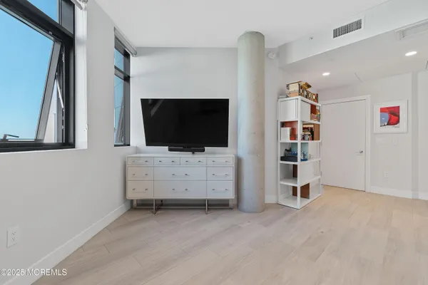 a living room with furniture and a book shelf