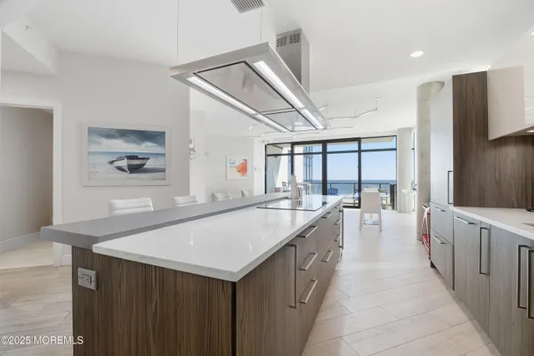 a large white kitchen with a large window