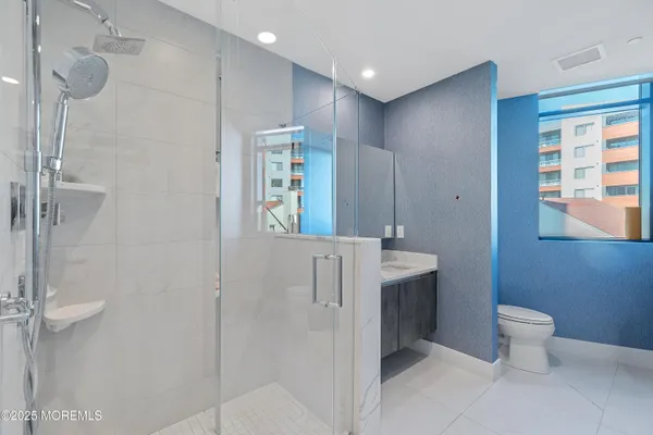 a bathroom with a toilet sink and shower