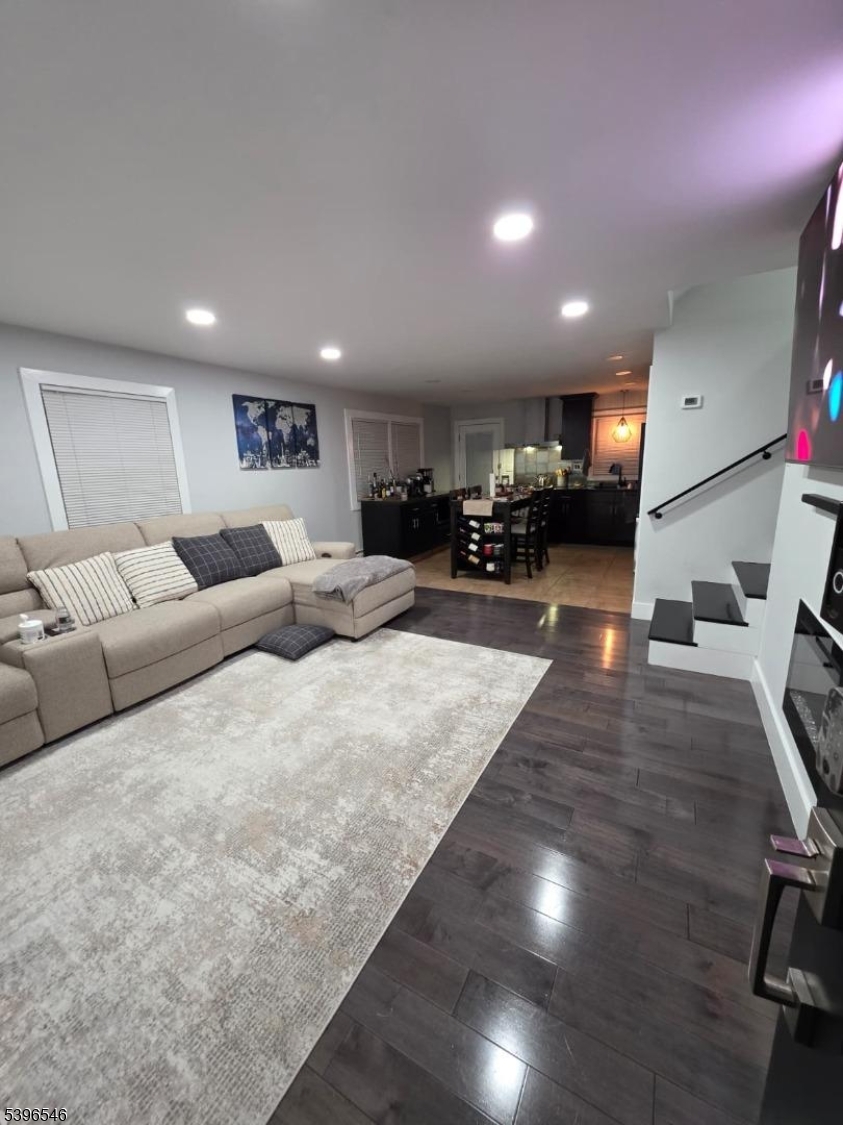 569 Harvard Avenue, Unit 1 Hillside, NJ 07205 - Photo 1 of 18 a living room with furniture and a wooden floor