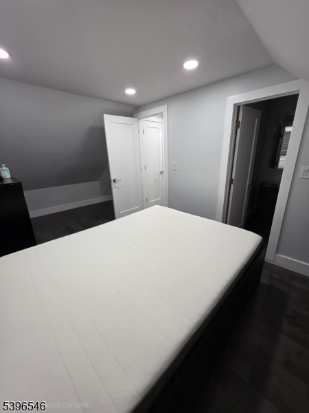 569 Harvard Avenue, Unit 1 Hillside, NJ 07205 - Photo 13 of 18 a large white bed in a white room