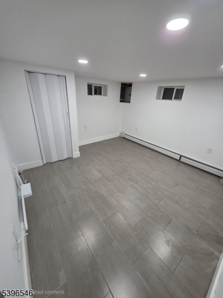 569 Harvard Avenue, Unit 1 Hillside, NJ 07205 - Photo 16 of 18 an empty room with a workbench