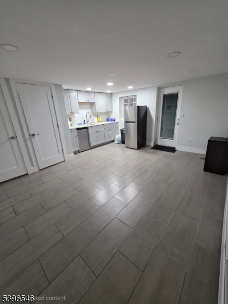 569 Harvard Avenue, Unit 1 Hillside, NJ 07205 - Photo 17 of 18 a view of a livingroom with furniture and cabinet