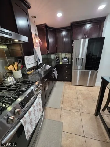 a kitchen with lots of counter top space and stainless steel appliances
