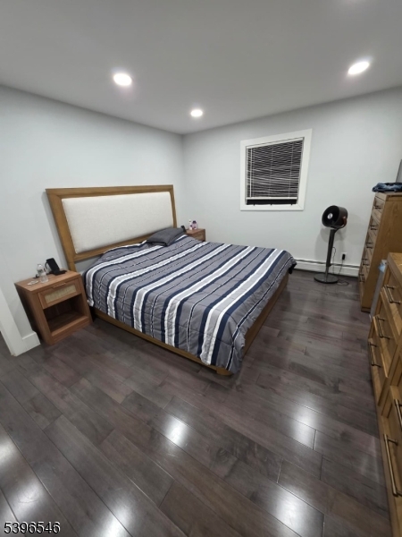 569 Harvard Avenue, Unit 1 Hillside, NJ 07205 - Photo 6 of 18 a bedroom with a bed and a flat screen tv