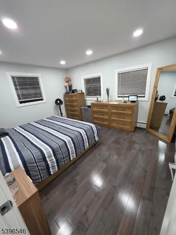 a bed room with two bed and a chair