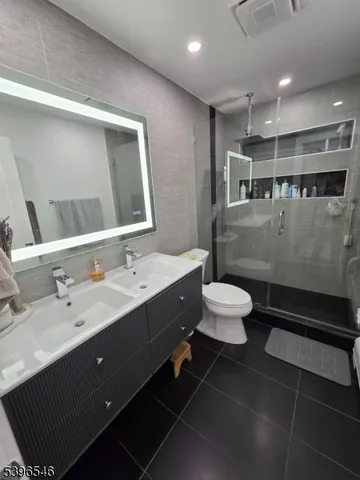 a bathroom with a double vanity sink toilet