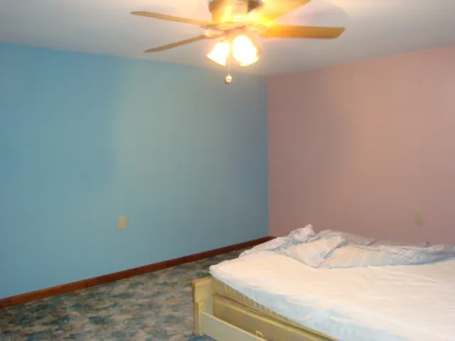 an empty room with furniture and natural light