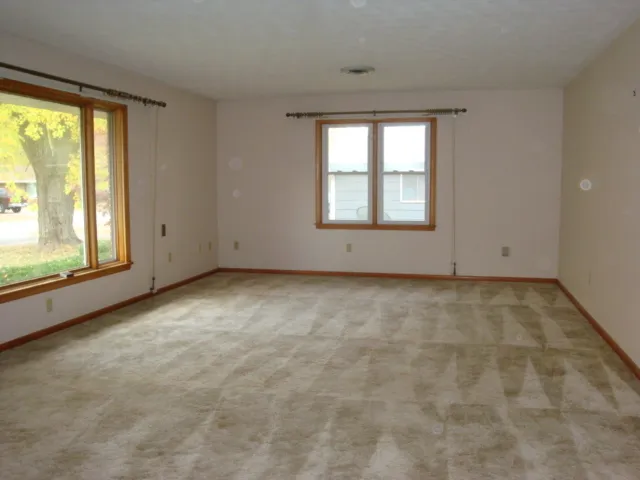 an empty room with a empty space and windows