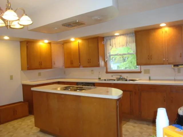 a room with table chairs and a refrigerator