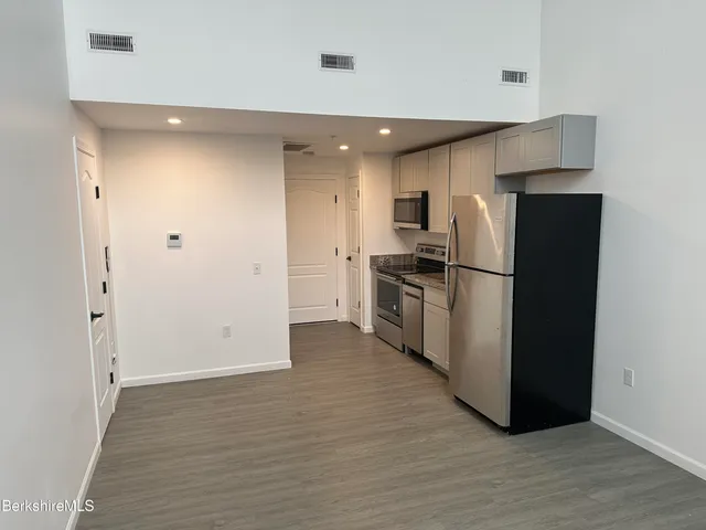 a kitchen with a refrigerator and a refrigerator