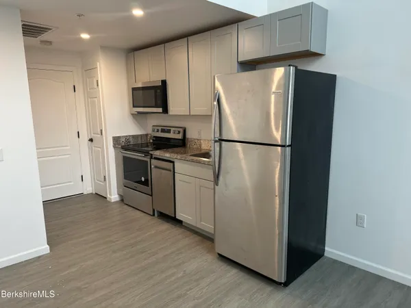 a white refrigerator freezer sitting in a kitchen