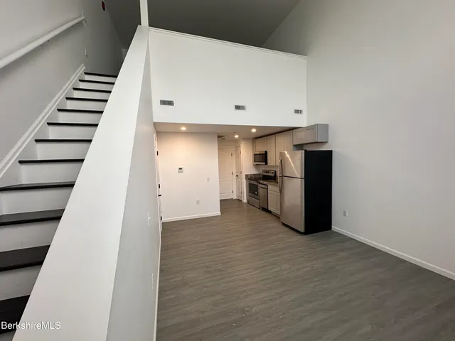 a view of kitchen with furniture and stainless steel appliances