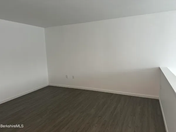 an empty room with wooden floor