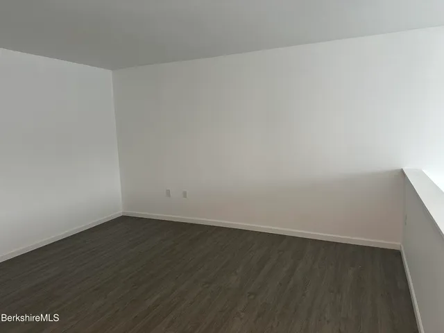 an empty room with wooden floor